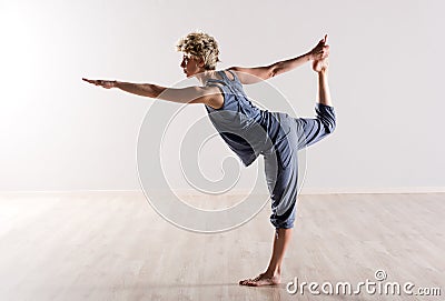 Woman in perfect balance while holding foot Stock Photo