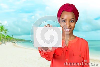 Woman with a perfect smile holds a business card Stock Photo