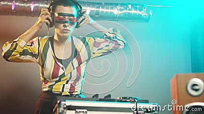 Woman performer mixing sounds at stereo turntables Stock Photo