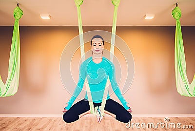 Woman performing antigravity yoga Stock Photo