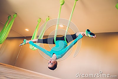 Woman performing antigravity yoga Stock Photo