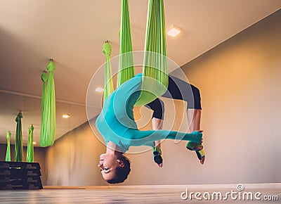 Woman performing antigravity yoga Stock Photo