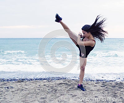 Woman performing a high kick Stock Photo