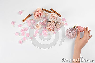 Woman with perfume. Fragrance composition, flowers and cinnamon on white background Stock Photo