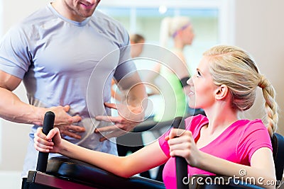 Woman with personal trainer doing sport Stock Photo