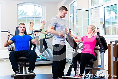 Woman with personal trainer doing sport Stock Photo