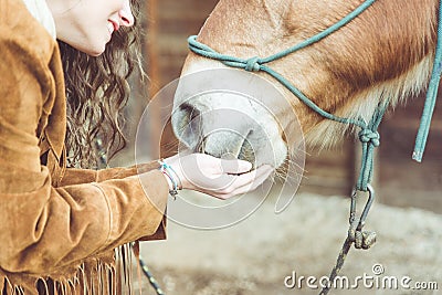 Woman petting her horse. Stock Photo