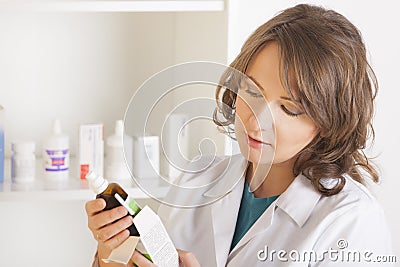 Woman pharmacist with a bottle of medicine Stock Photo