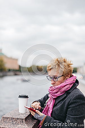 Woman with phone on esplanade Stock Photo