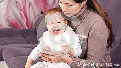 the woman on the phone, ignores the crying child. Stock Photo