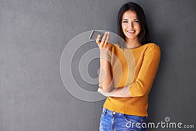 Woman, phone and wall background for mockup, smile and portrait in fashion for social media. Technology, digital and Stock Photo