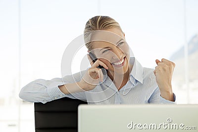 Woman on the phone at workplace - using mobile phone Stock Photo