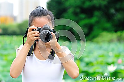 Woman photo grapher taking photo Stock Photo