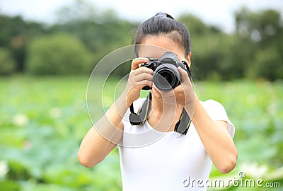 Woman photo grapher taking photo Stock Photo