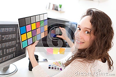 Woman photographer calibrate her screen Stock Photo