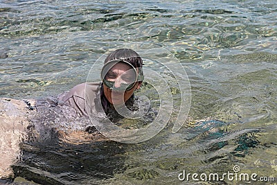 Woman photographer diving into water of Red sea Editorial Stock Photo