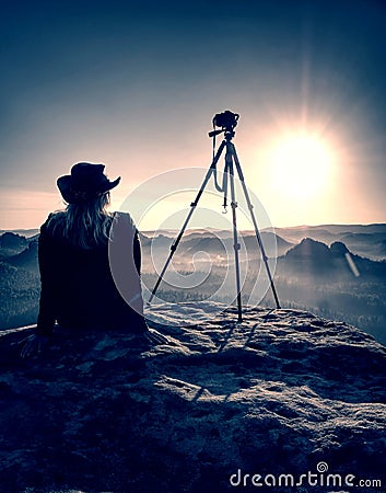 Woman photographer take a rest after taking picture of landscape Stock Photo