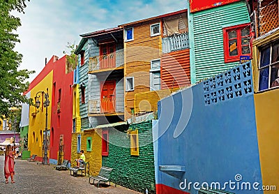 Woman photographing a child in front of colorful buildings of the Argentinean district La Boca, in Buenos Aires, during Stock Photo