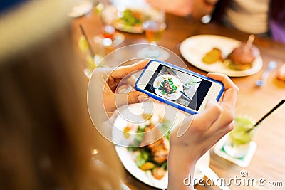 Woman photographing food by smartphone Stock Photo