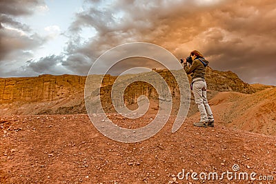 Woman photographing sunset landscape in Marrakech Editorial Stock Photo