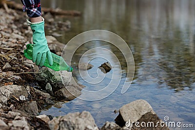 Woman picking up dump on dirty forest Stock Photo