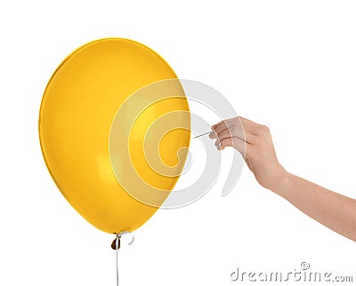 Woman piercing blue balloon Stock Photo