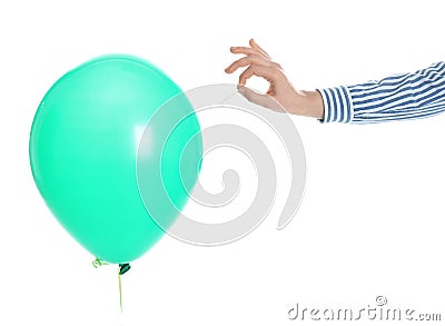 Woman piercing green balloon on white background Stock Photo