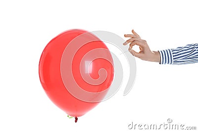 Woman piercing red balloon on white background Stock Photo