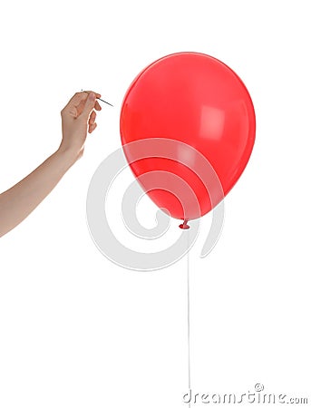 Woman piercing red balloon Stock Photo