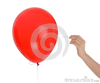 Woman piercing red balloon Stock Photo