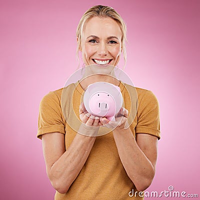 Woman, piggybank and portrait smile for savings, investment or cash money against a pink studio background. Happy female Stock Photo