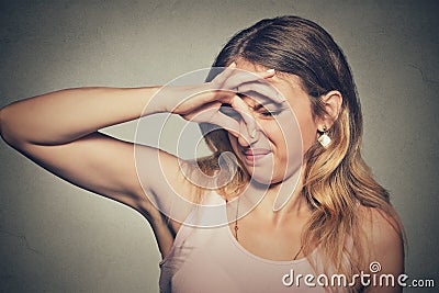 Woman pinches nose with fingers looks with disgust something stinks bad smell Stock Photo