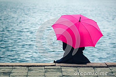 Woman with pink umbrella Stock Photo