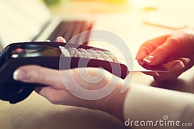 Woman placing credit card into reader Stock Photo