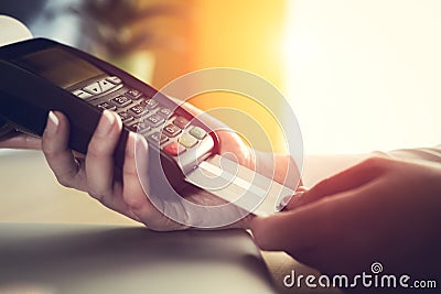 Woman placing credit card into reader Stock Photo