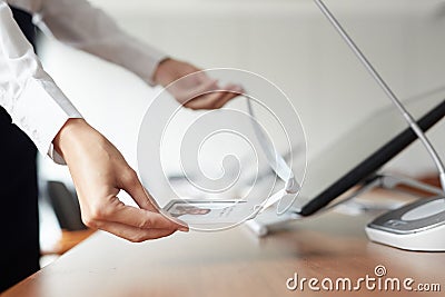 Woman Placing ID Card on Table Stock Photo