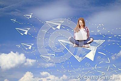 Woman on plane using laptop Stock Photo