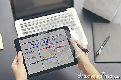 Woman planning agenda and schedule using calendar event planner. Stock Photo