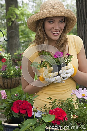 Woman planting flowers in her garden Stock Photo