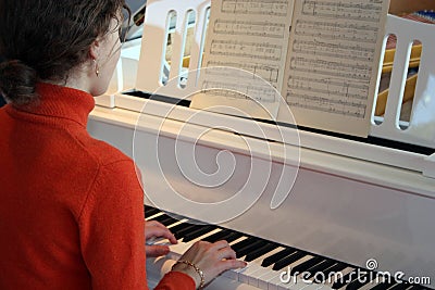 Woman play on piano Stock Photo