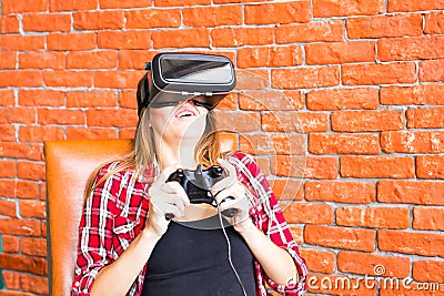 Woman play video game with joystick and VR device Stock Photo