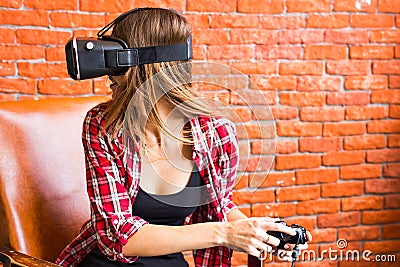 Woman play video game with joystick and VR device Stock Photo