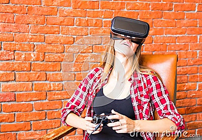 Woman play video game with joystick and VR device Stock Photo