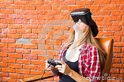 Woman play video game with joystick and VR device Stock Photo