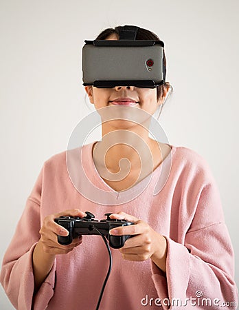 Woman play video game with joystick and vr device Stock Photo