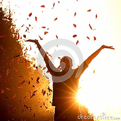 Woman playing with autumn leaves Stock Photo