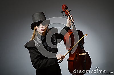 Woman playing classical cello in music concept Stock Photo