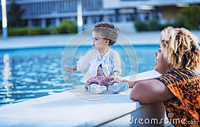 Mother and daughter having fun with fountain water Stock Photo