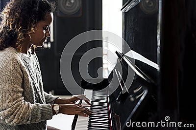 Woman playing on a piano Stock Photo