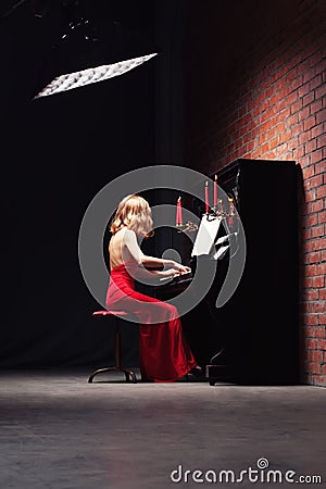 Woman playing the piano Stock Photo